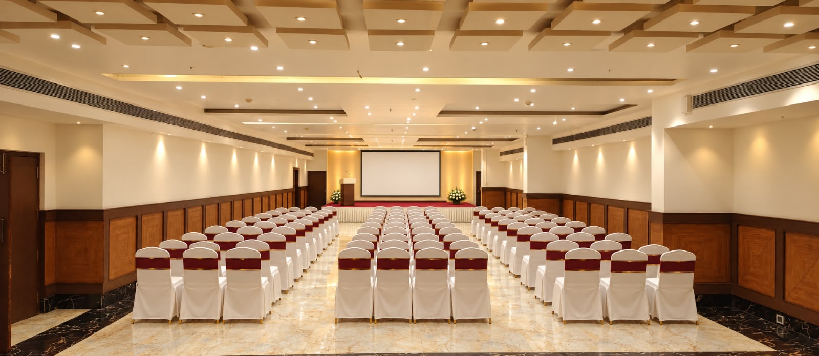 Grand Banquet Hall theatre-style setup at Hotel Preethi International, Mysuru